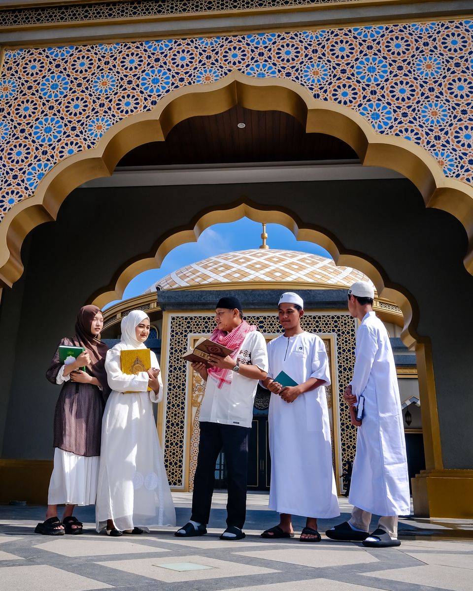 Young Muslims talking together at the entrance of a mosque